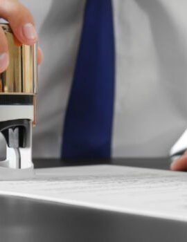 A businessman placing a stamp on a document symbolizing approval