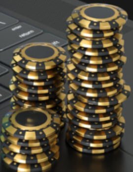 Poker chips stacked on top of a laptop symbolizing online gambling
